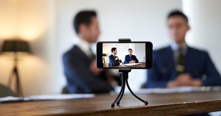 men in suits talking on camera