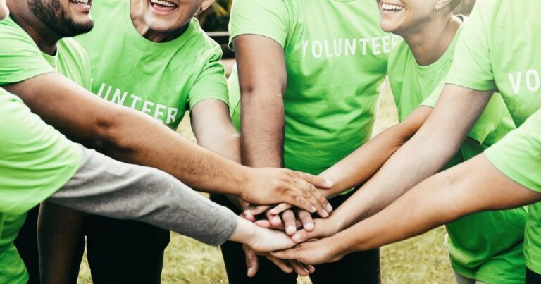 volunteers with green shirts